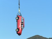 photo of red car suspended in midair for professional car stunt, hollywood Stunts Unlimited