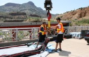 stunt crew setting up safety gear for a major professional bungee stunt