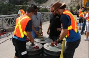 professional bungee stunt crew attaching bungee cords to strong base